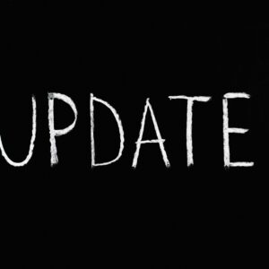 Bold 'UPDATE' text written in chalk on a blackboard. Perfect for concepts of change and communication.