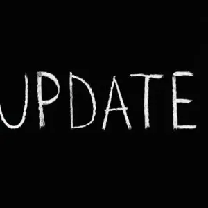 Bold 'UPDATE' text written in chalk on a blackboard. Perfect for concepts of change and communication.